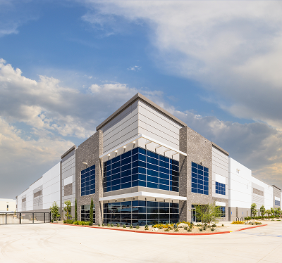 Modern industrial building with blue glass windows.