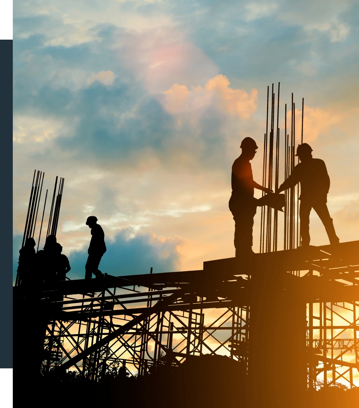 Construction workers silhouetted against sunset sky.