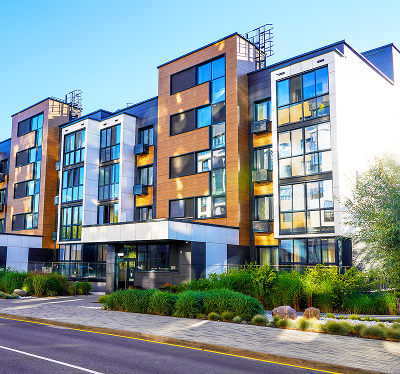 Modern apartment building with landscaped surroundings.