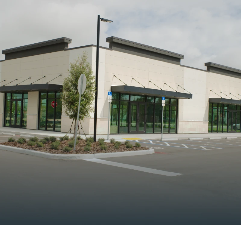 Empty commercial building with parking lot.
