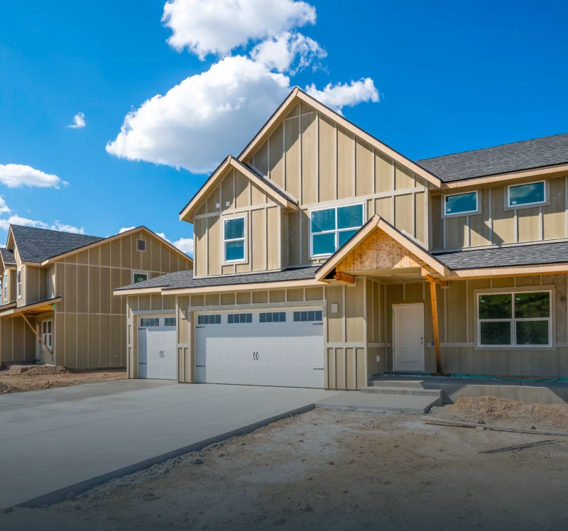 Newly built suburban house under blue sky.