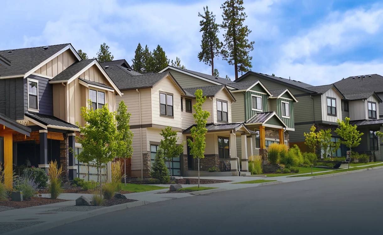 Row of modern suburban houses under sky.